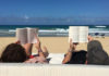 Couple reading at the beach